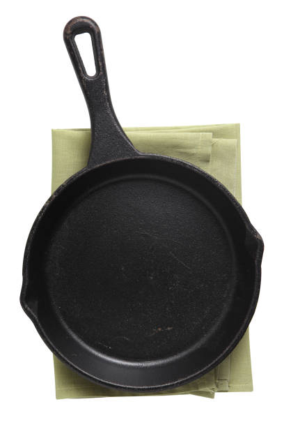 istock Empty iron pan and napkin isolated on white background 1254003570