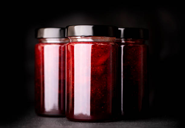 istock Jar of strawberry jam on a dark background 1254006763