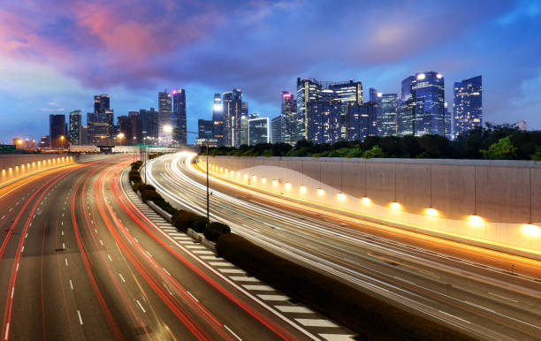 istock Singapore skyline at night with traffic 1254008807