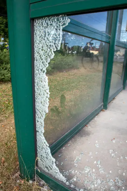 Photo of broken glass at a train station platform shelter