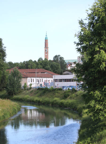 istock River called Bacchiglione in Vicenza City and the ancient Tower 1254011186
