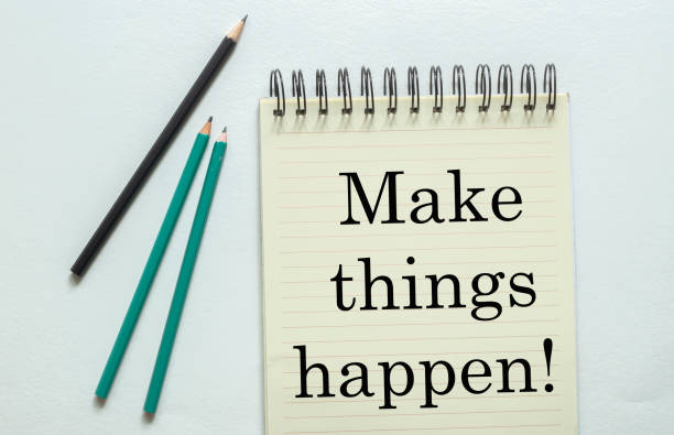 two green one black pencil with text Make things happen!Â  in the notebook on the white background two green one black pencil with text Make things happen!Â  in the notebook on the white background escribir stock pictures, royalty-free photos & images