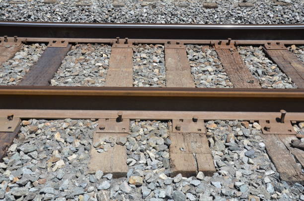 istock iron metal railroad train tracks with stones 1254012338