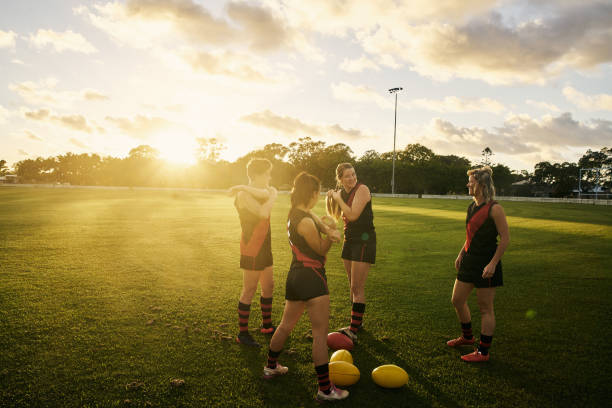 Getting ready to play a good game Shot of a group of young women out on the field for a game of football sports training australia stock pictures, royalty-free photos & images