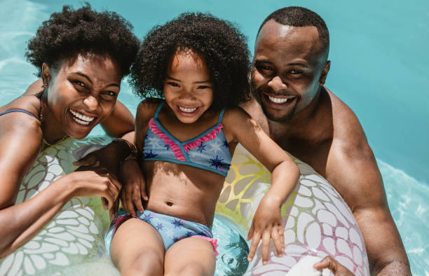 istock Family in pool in a summer day 1254013201