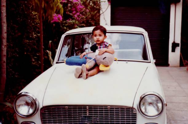 A child playing and driving with his friend. Old photograph digitally restored.