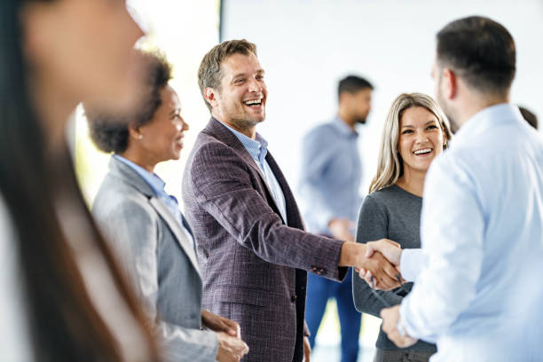 istock Happy businessmen greeting each other at corporate office. 1254014390