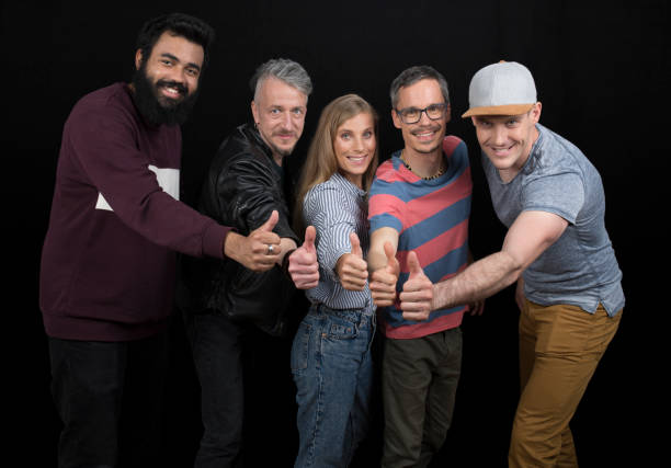 Portrait of people standing together and showing hand sign.