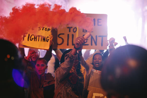 istock Group of people protesting with smoke grenades 1254015533