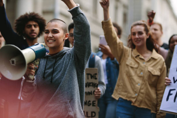 istock Woman with megaphone during street protest 1254016475