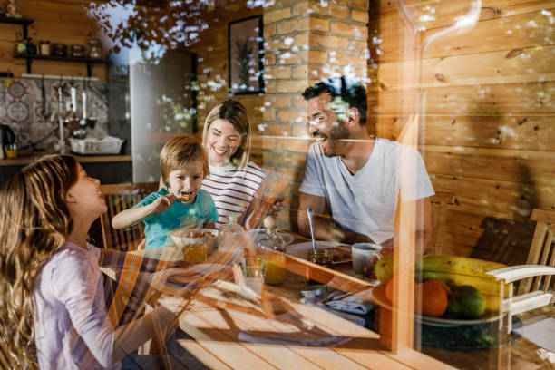 istock Young happy family enjoying in their breakfast at dining table. 1254017775