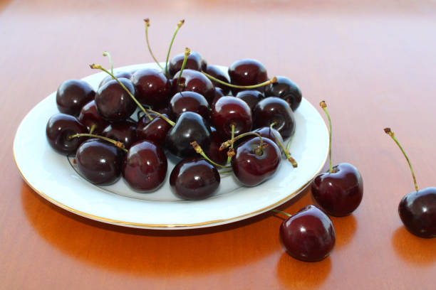 istock Dark red cherry fruits in the plate 1254019270