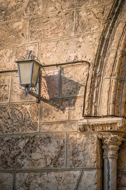 istock Vintage lantern and its shadow on an old wall. Details. Jerusalem, Israel 1254022496