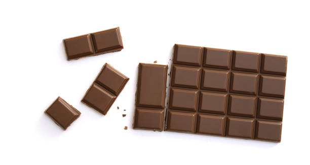 istock Chocolate pieces isolated on white background from top view 1254024490