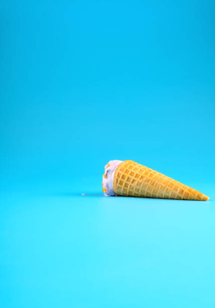 istock sweet potato flavor ice cream cone in a melting process on blue background vertical composition 1254026778