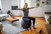 Woman doing online workout at home