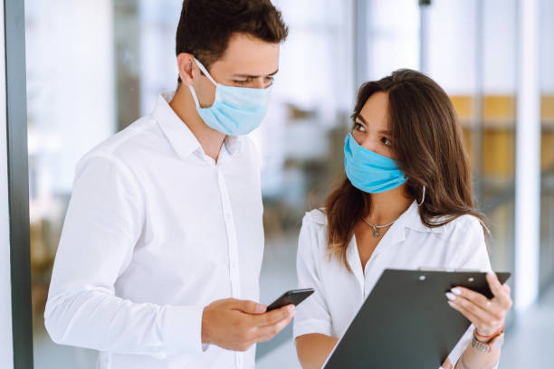 istock Business people with face mask working in the office. 1254027077