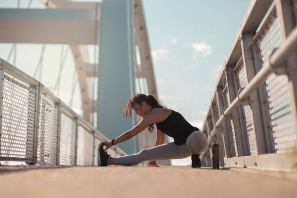 istock Young woman doing a stretching exercise 1254028134