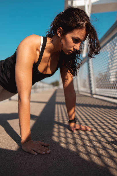 istock Young woman working out at the bridge 1254028301