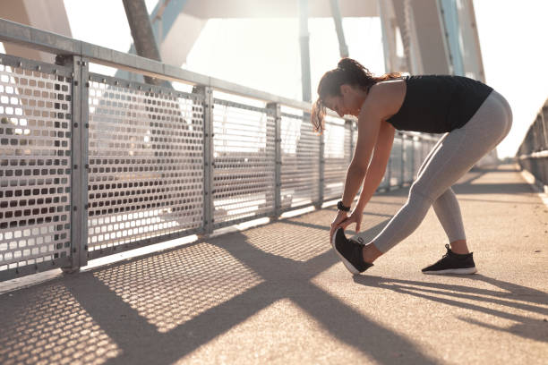 istock Young woman doing a leg stretching exercise 1254028467