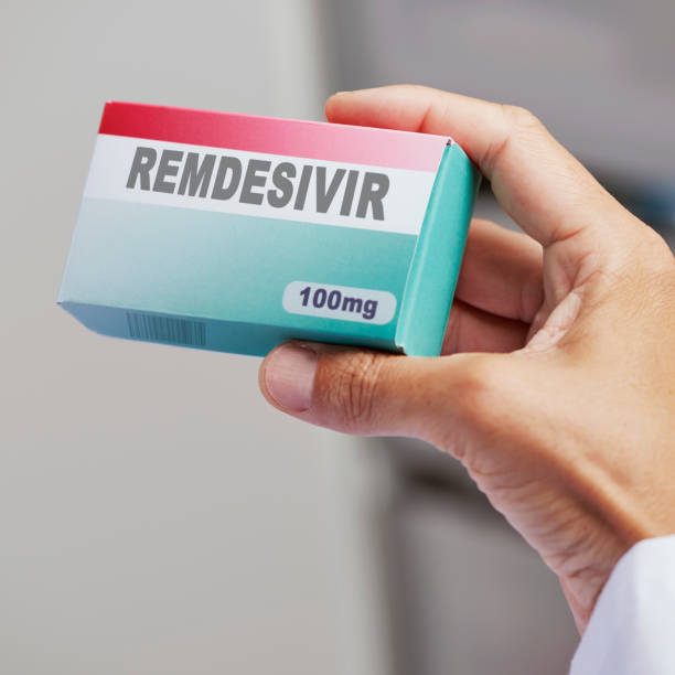 istock man with a simulated box of remdesivir 1254031630