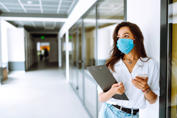 istock Office worker with face mask working in the office. 1254034582