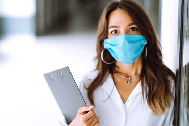 istock Office worker with face mask working in the office. 1254034598