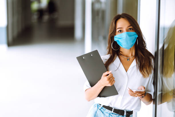 istock Office worker with face mask working in the office. 1254034756