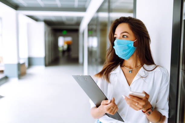 istock Office worker with face mask working in the office. 1254034774