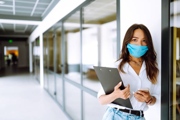 istock Office worker with face mask working in the office. 1254034796