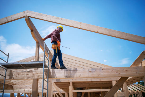 istock Construction Workers Working On Wooden Roof Of House. 1254035507