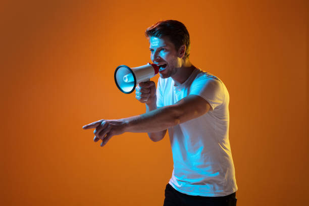 istock Caucasian beautiful young man's portrait on gradient orange studio background, emotional and expressive. Copyspace for ad. 1254036718
