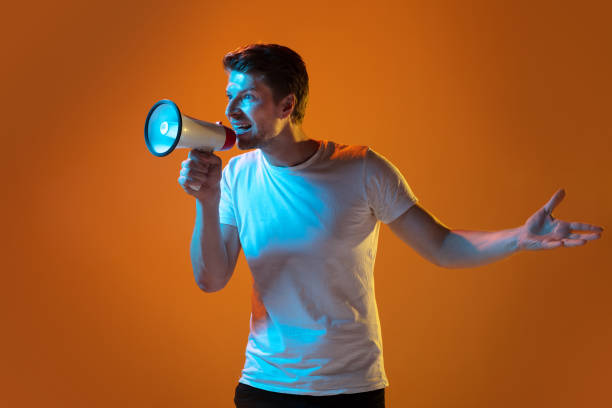 istock Caucasian beautiful young man's portrait on gradient orange studio background, emotional and expressive. Copyspace for ad. 1254036720