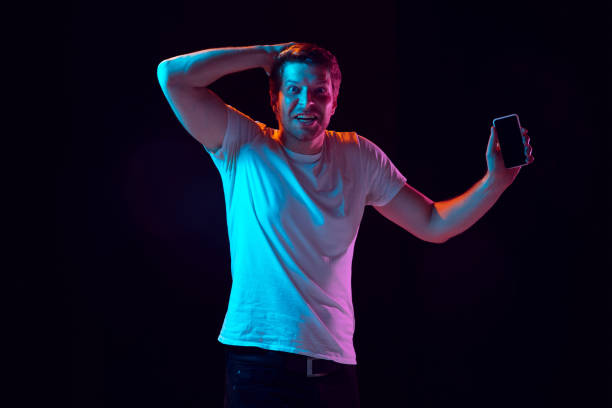 istock Caucasian beautiful young man's portrait on black studio background, emotional and expressive. Copyspace for ad. 1254036775