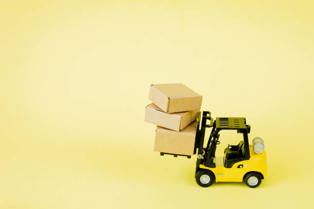 istock Mini forklift truck load cardboard boxes. Logistics and transportation management ideas and Industry business commercial concept. 1254038098