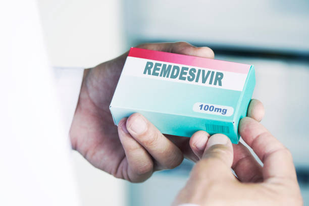 istock man with a simulated box of remdesivir 1254038578