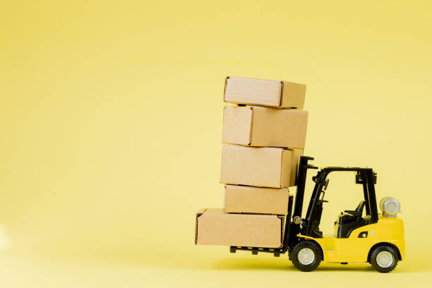 istock Mini forklift truck load cardboard boxes. Logistics and transportation management ideas and Industry business commercial concept. 1254043493