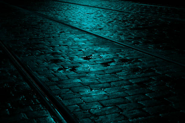 Turquoise Light on a Wet Cobbled Tramway at Night, Ireland