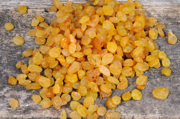istock Raisins on a wooden background. View from above. 1254045223