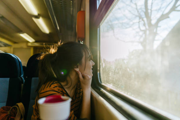 istock Smiling woman on a train 1254045340