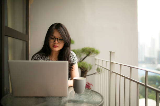 istock asian beautiful woman using laptop and working from home 1254045394