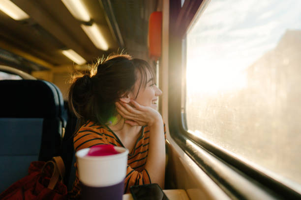 istock Smiling woman on a train 1254045445
