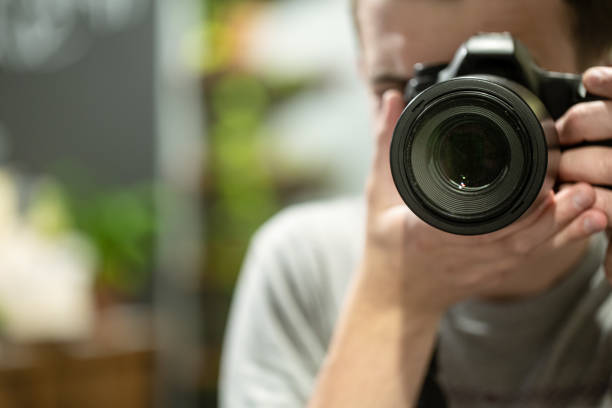 istock Reflection in the mirror of a man with a camera. 1254045540