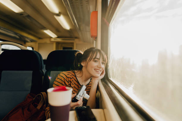 istock Smiling woman on a train 1254045634