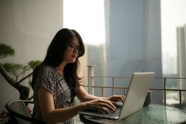 istock asian beautiful woman using laptop and working from home 1254045962