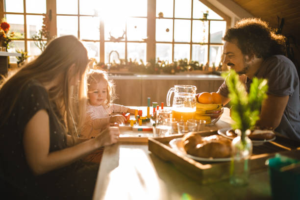 istock Caring father with pride in his eyes looking at his toddler girl how she every day develop her creative skills 1254046675