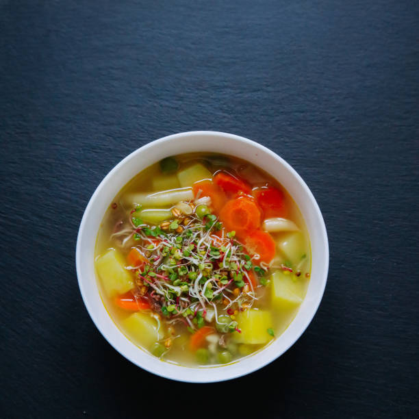istock Vegetable soup in a bowl isolated on dark background. 1254047475