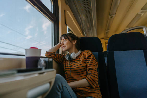 istock Smiling woman on a train 1254048609