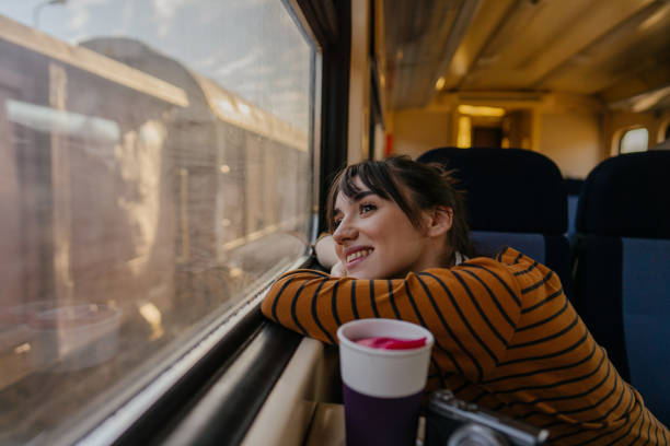 istock Smiling woman on a train 1254048612