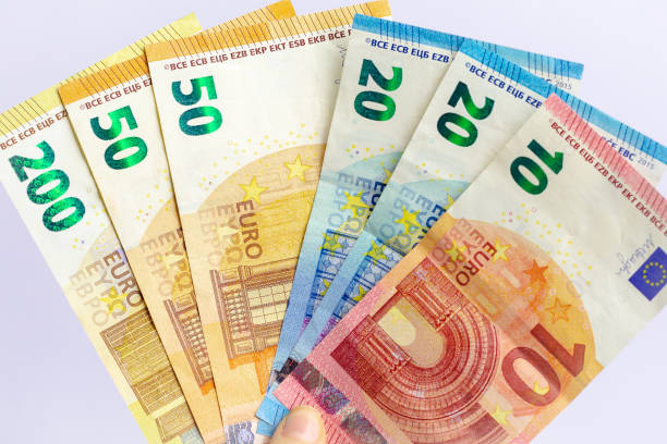 istock Euro banknote in woman's hand. 1254048640